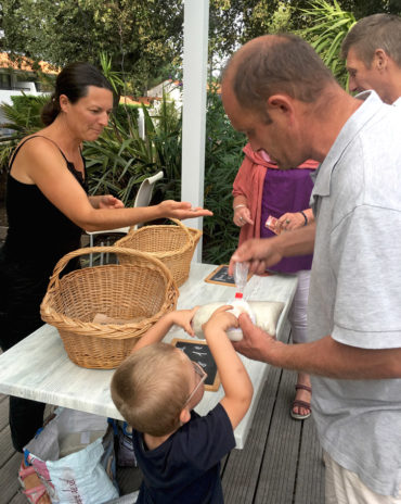 Une paludière est venu présenter ses produits aux vacanciers. Dominique et son fils achètent du sel avec Damien.